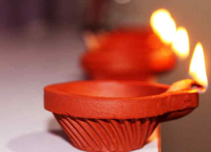 Lit earthen lamp representing the 4 elements