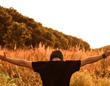 Guy hands outstretched praying