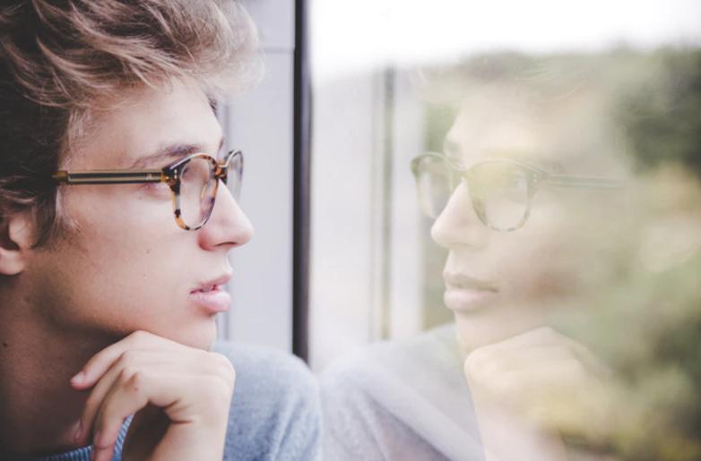 Guy looking at his own reflection